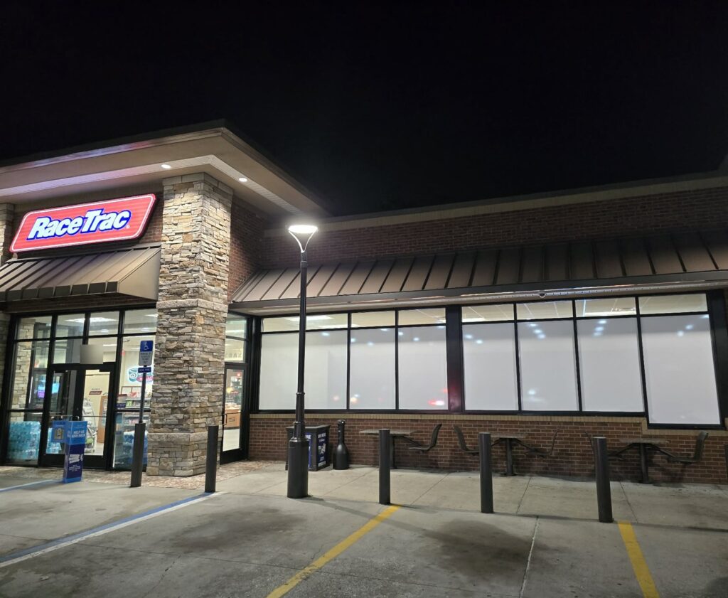 Commercial window film on a long run of convenience store windows at night