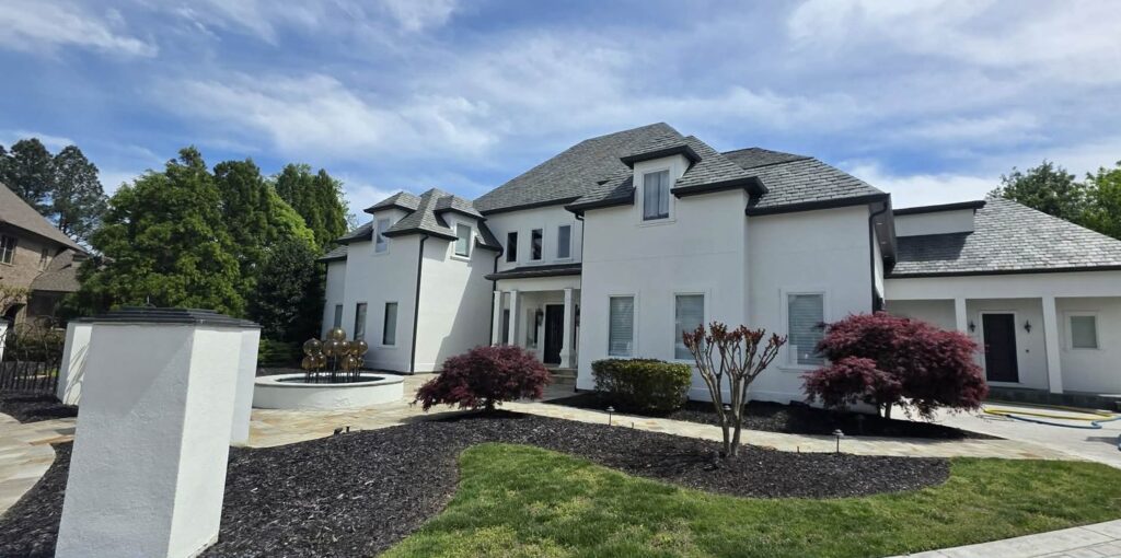 Large white stucco home in Hixson, TN with window film on its windows