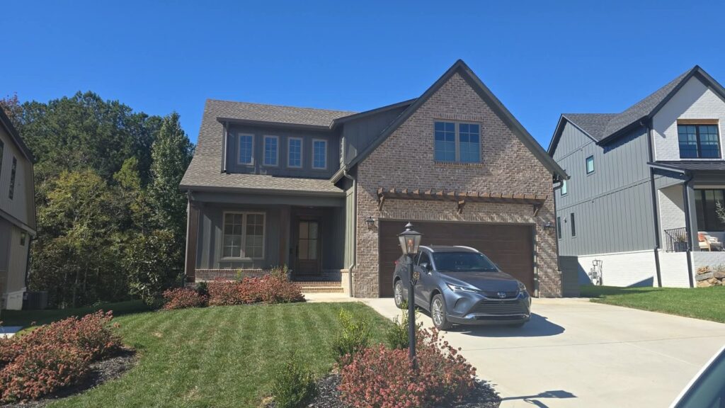 Front of a brick and board-and-batten home in Jasper Highlands where Solar Sentinel installed window film