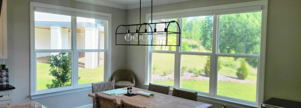Dining room in a newly built home with large double windows and residential window film