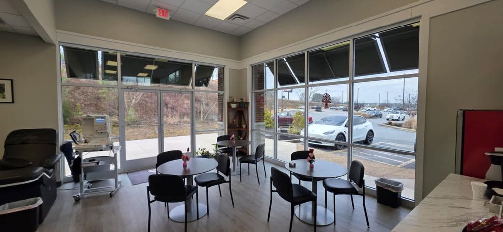 Commercial lobby with a wall of floor-to-ceiling windows and window film by Solar Sentinel