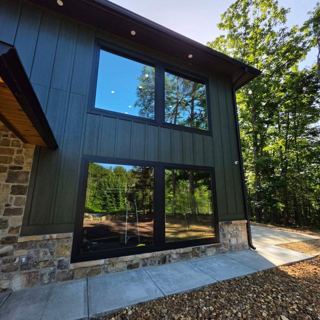 Wooded Soddy-Daisy, TN home with reflective window film on its tall two-story windows